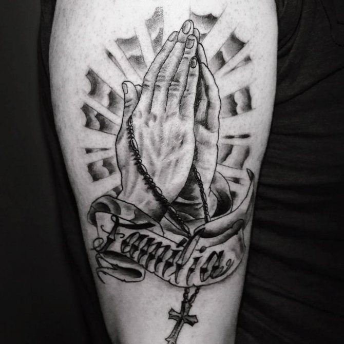mains priant avec une croix