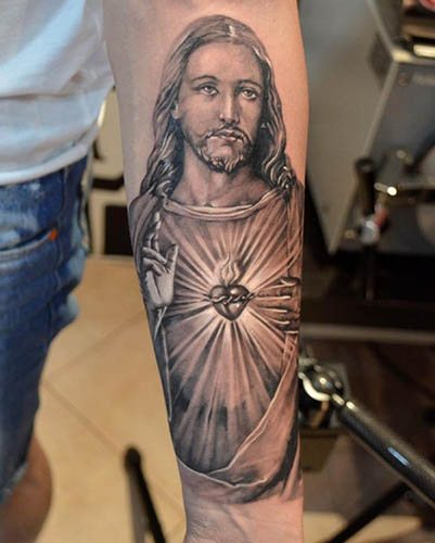 Tatouage de Jésus sur le bras, le dos, l'épaule, la poitrine. Signification, sur la croix, avec le diable, machine, colombe
