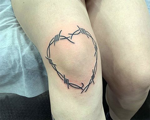 Tatouage d'un cœur en fil de fer barbelé