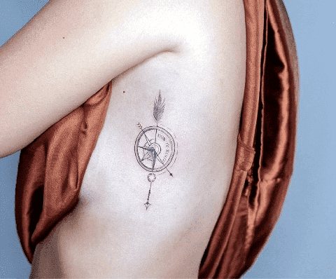 Boussole tatouée sur le côté d'une fille