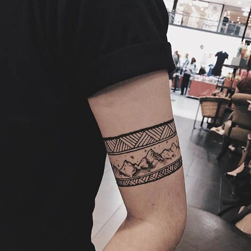 Tatouage autour du biceps homme, femme. Photo : dans le style slave, sous la forme d'un motif scythique de nœuds celtiques.